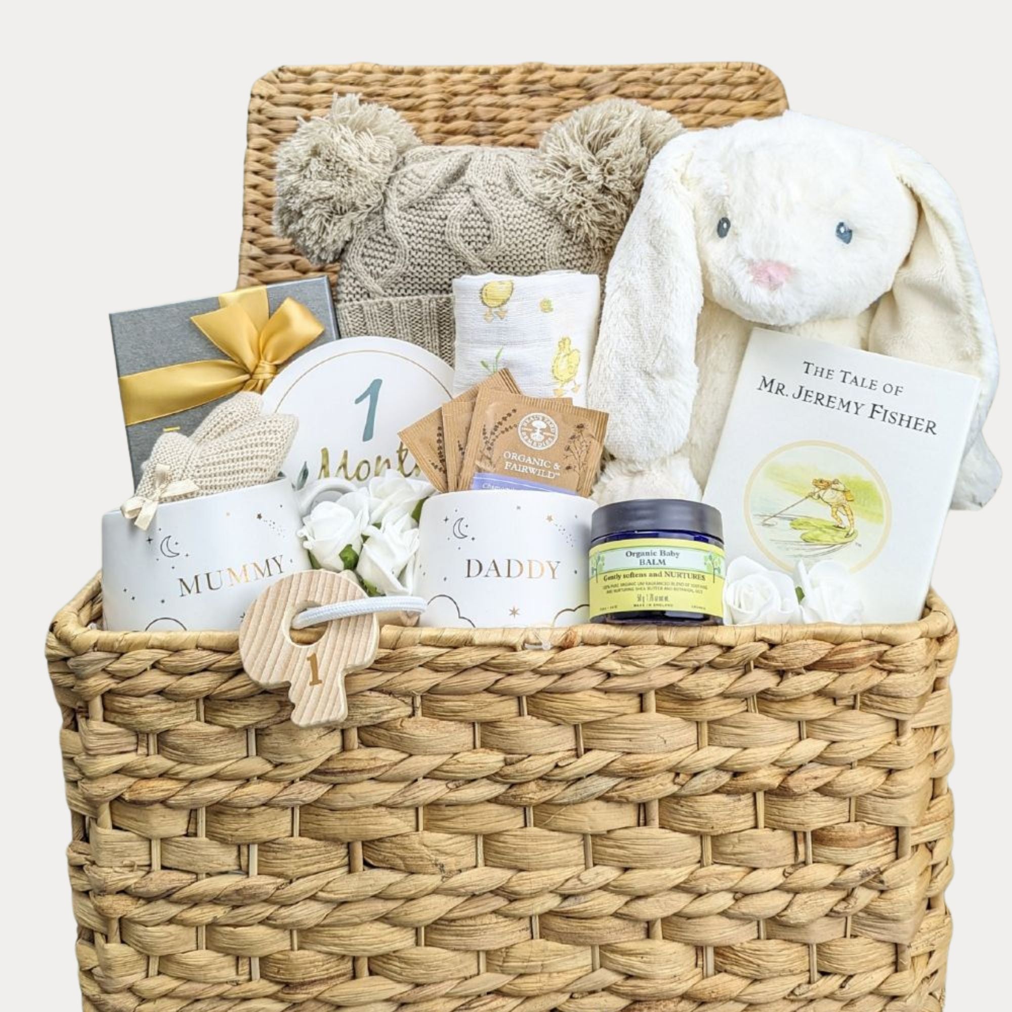 new mum and dad gift hamper with chocolate for the new parents and mugs plus book and bunny for baby