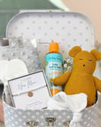 new mum gift hamper trunk with mustard teddy bear, silver bracelet for mum, organic wash and baby essentials.