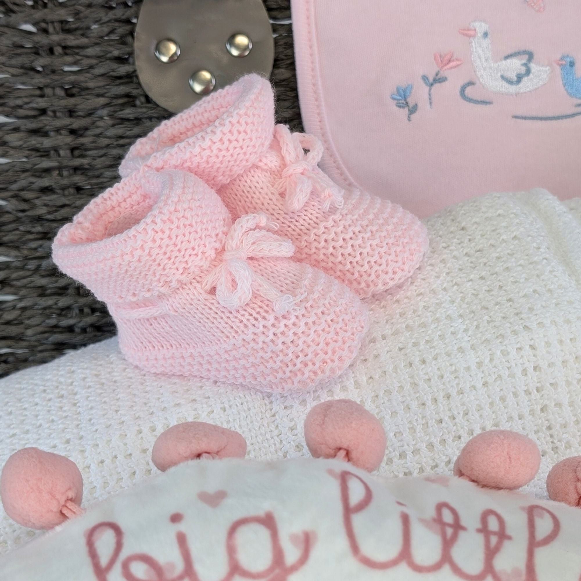 a large new mum hamper basket which includes chocolates, bracelet, reddy bear, teething toy, clothing set, blanket, booties and keepsake basket.