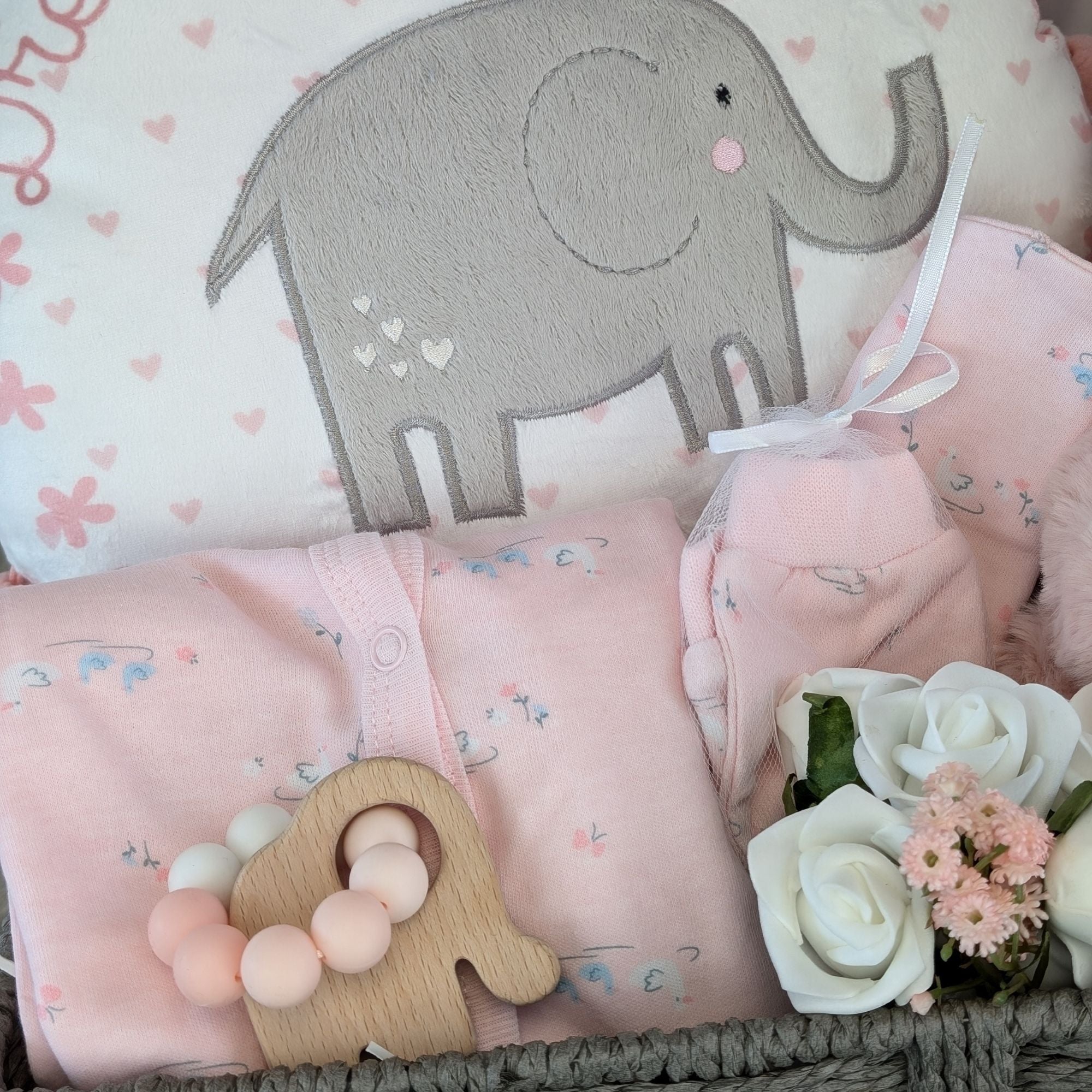 a large new mum hamper basket which includes chocolates, bracelet, reddy bear, teething toy, clothing set, blanket, booties and keepsake basket.