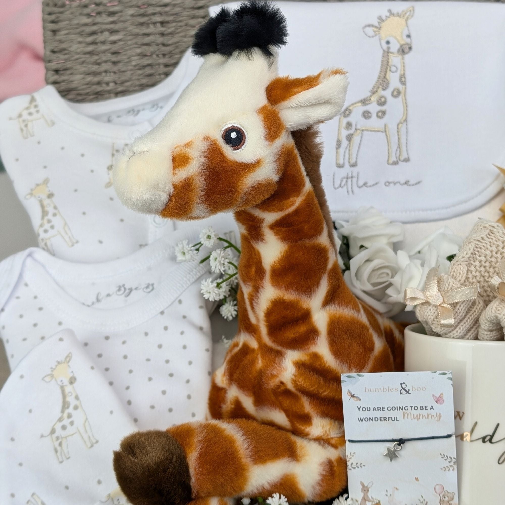 new mum gifts basket with giraffe theme baby clothing, giraffe soft toy, chocolates, baby booties, mug for daddy and wish bracelet for mummy
