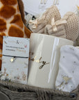 new mum gifts basket with giraffe theme baby clothing, giraffe soft toy, chocolates, baby booties, mug for daddy and wish bracelet for mummy