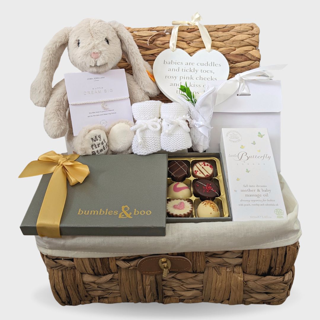 New mum gifts hamper basket, with bunny toy and chocolates.