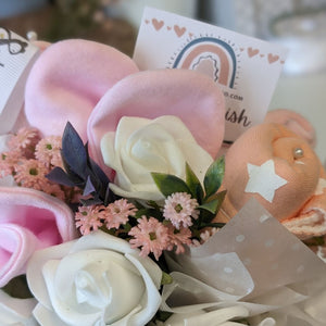 new mum gifts bouquet which includes mittens, socks and bandana bibs.