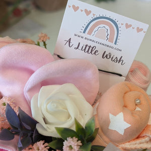 new mum gifts bouquet which includes mittens, socks and bandana bibs.