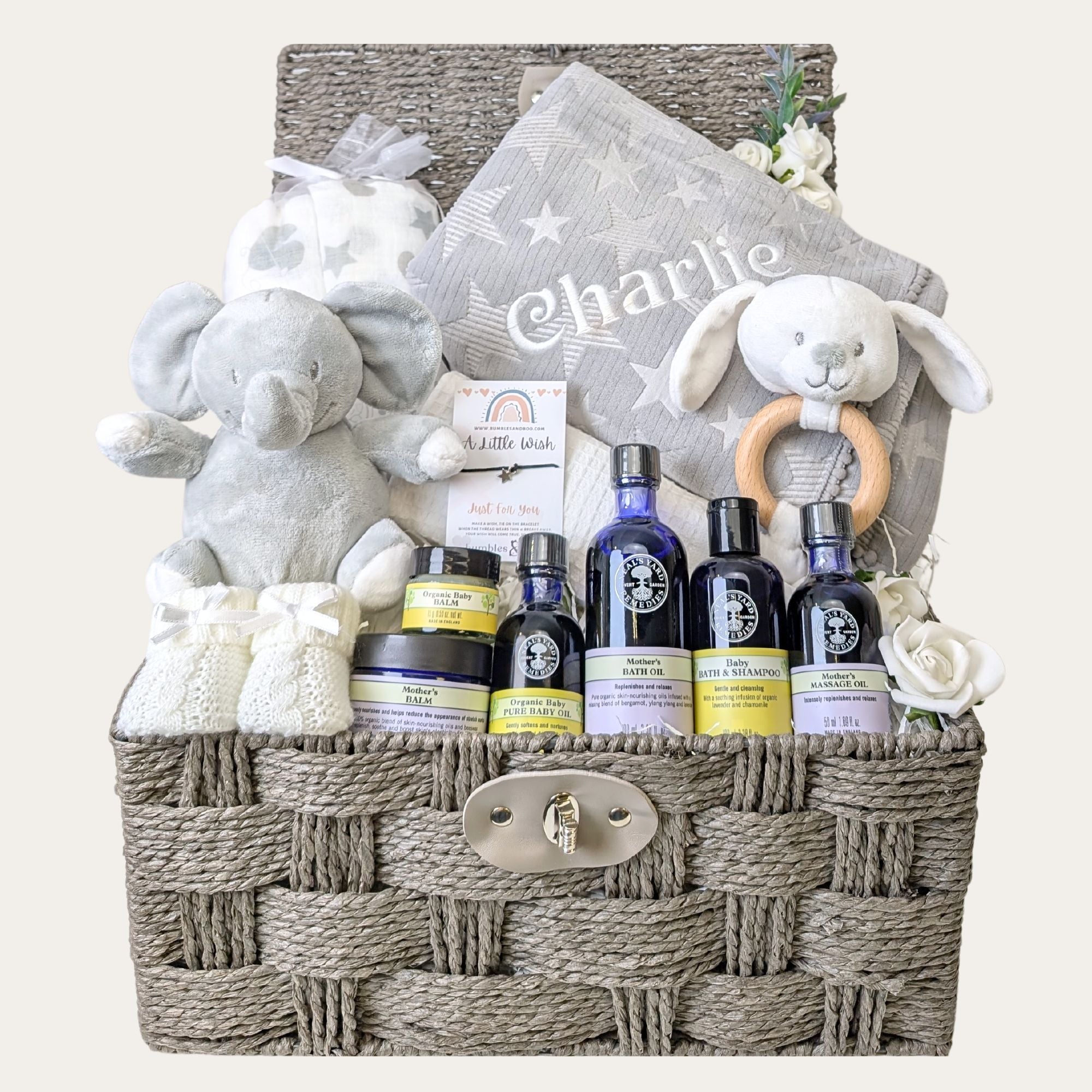 new mum and baby basket with elephant soft toy, baby blanket, muslin squares, bunny rattle and baby booties. Bumbles and boo.