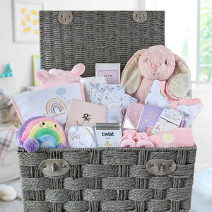 Large baby girl hamper gifts basket with bunny and clothing.