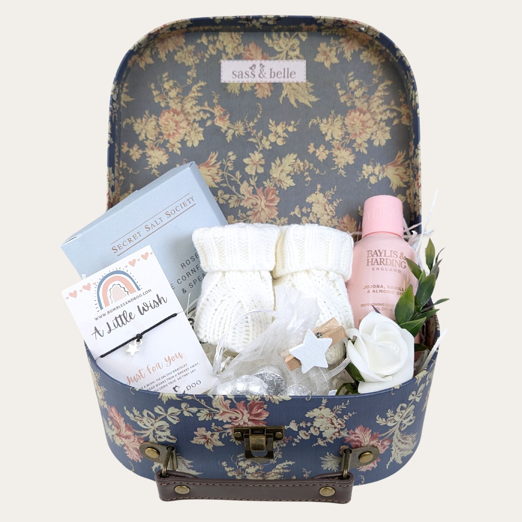 floral luggage gifts trunk filled with products to pamper a new mum.