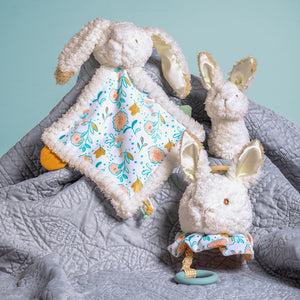 A bunny comforter soother with satin ears in neutral tones and colour palette