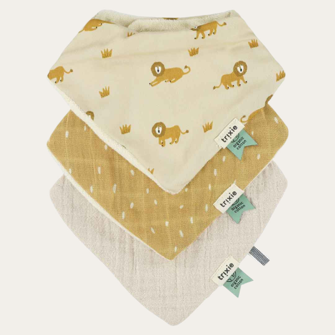 All three Organic Bandana Bibs displayed, showing the lion print and two solid muslin colours