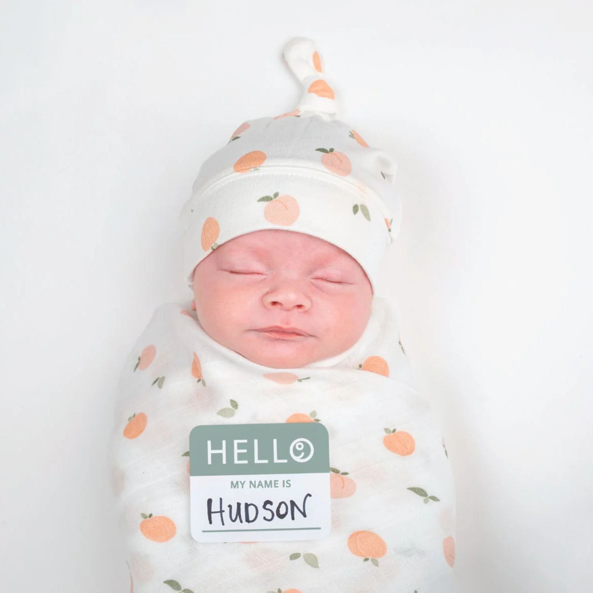 Adorable baby knot hat and swaddle set with unisex peach design using natural bamboo materials, Lulujo 