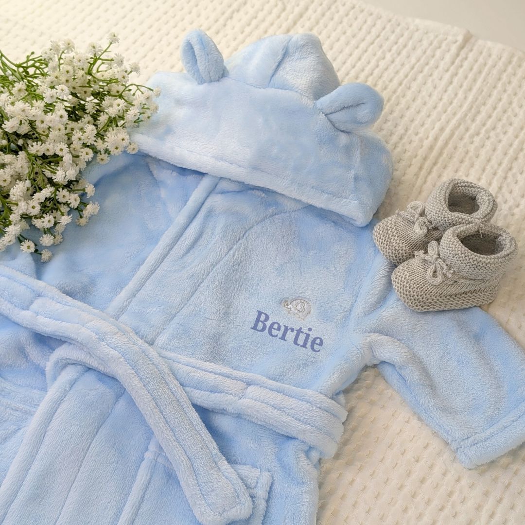 Personalised baby boy bathrobe in blue. This dressing gown has  ears on the hood and is personalised with baby's name.