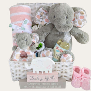 personalised baby girl gifts basket with elephants and blanket, packed in a white hamper basket.