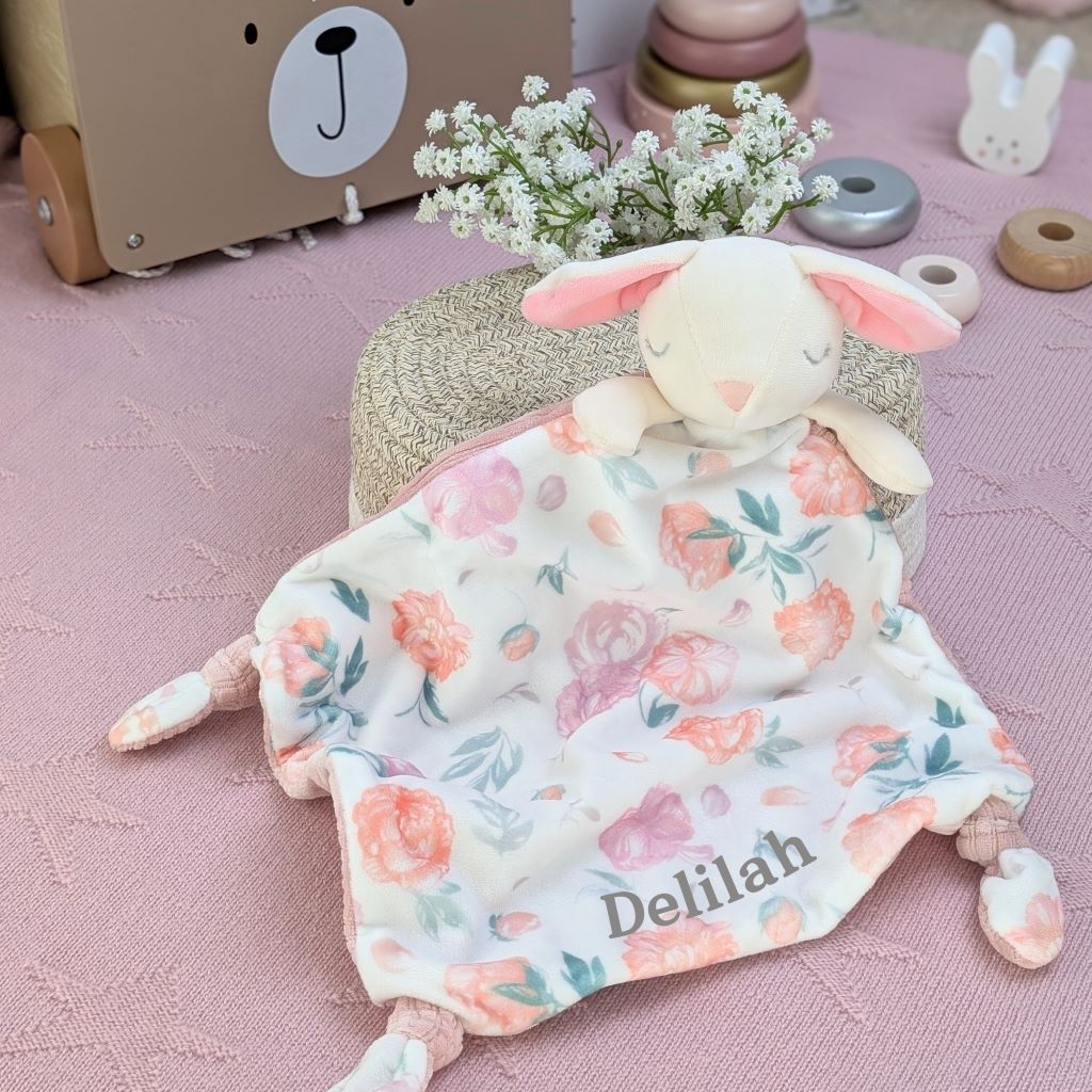 Floral baby comforter in the shape of a bunny rabbit personalised with the baby's name.