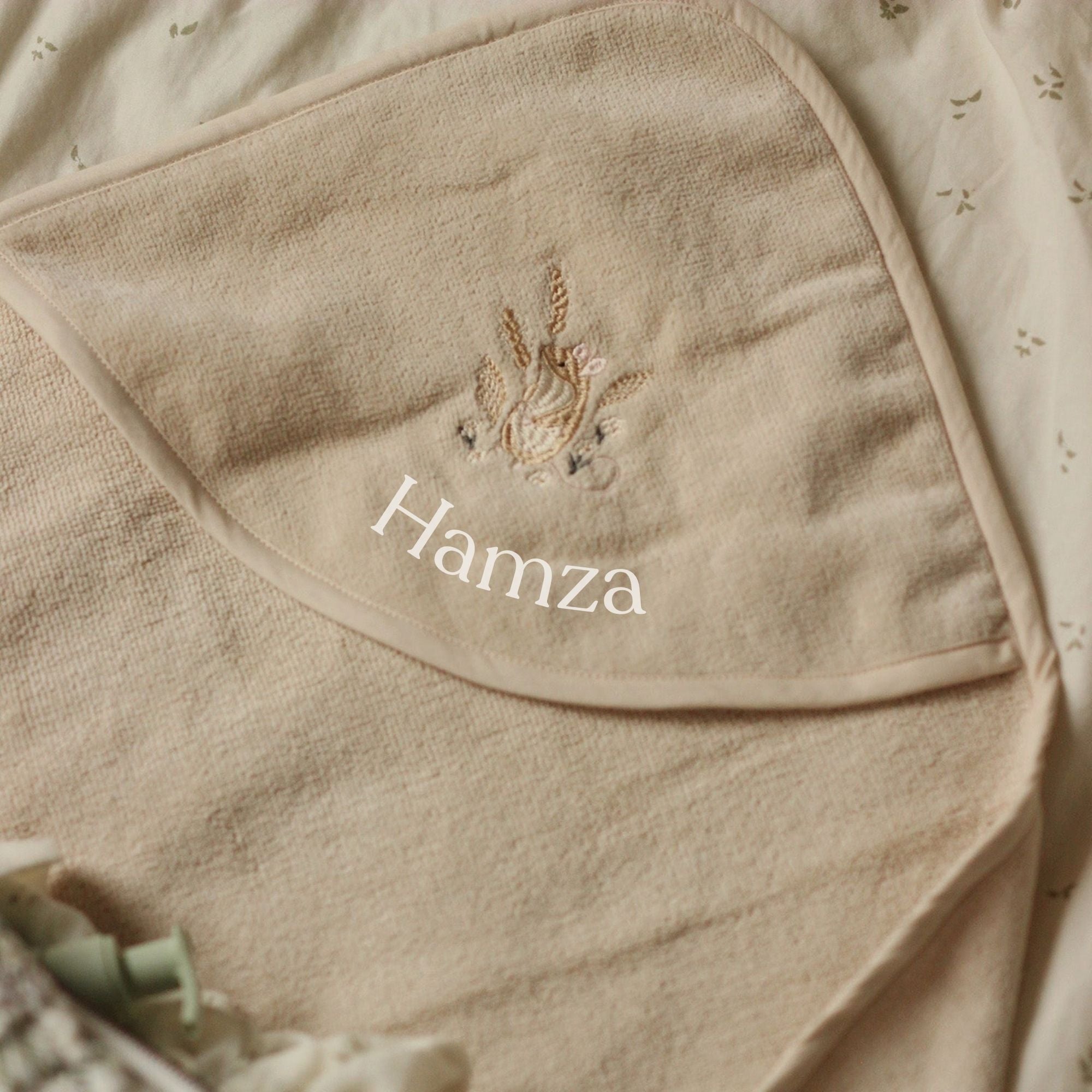 plain hooded baby towel with mouse motif in a neutral beige colour.