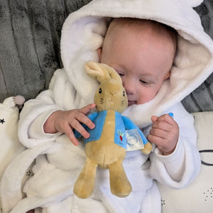 Baby playing with Beatrix Potter Peter Rabbit baby toy.