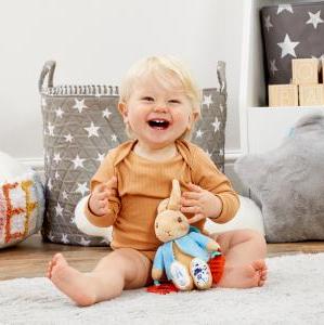 Peter Rabbit Activity Toy. Designed to stimulate baby's senses and encourage early sensory development, this super soft toy rattles and squeaks as baby plays, and features an attached teether, crinkle-sound fabric, different textures and silky tags for little fingers to explore.