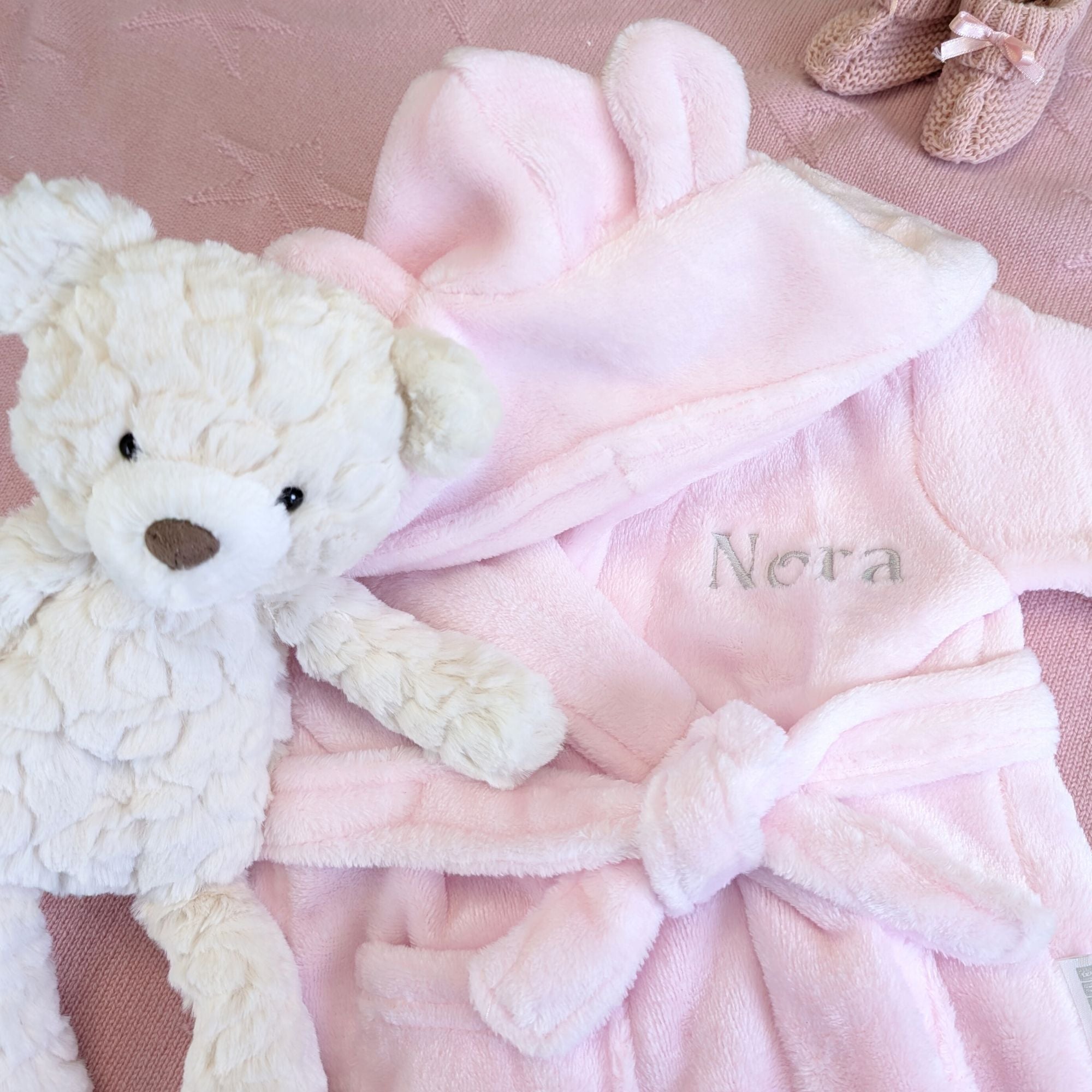 Personalised pink baby dressing gown. This bath robe has ears on the hood and is personalised with the baby's name.