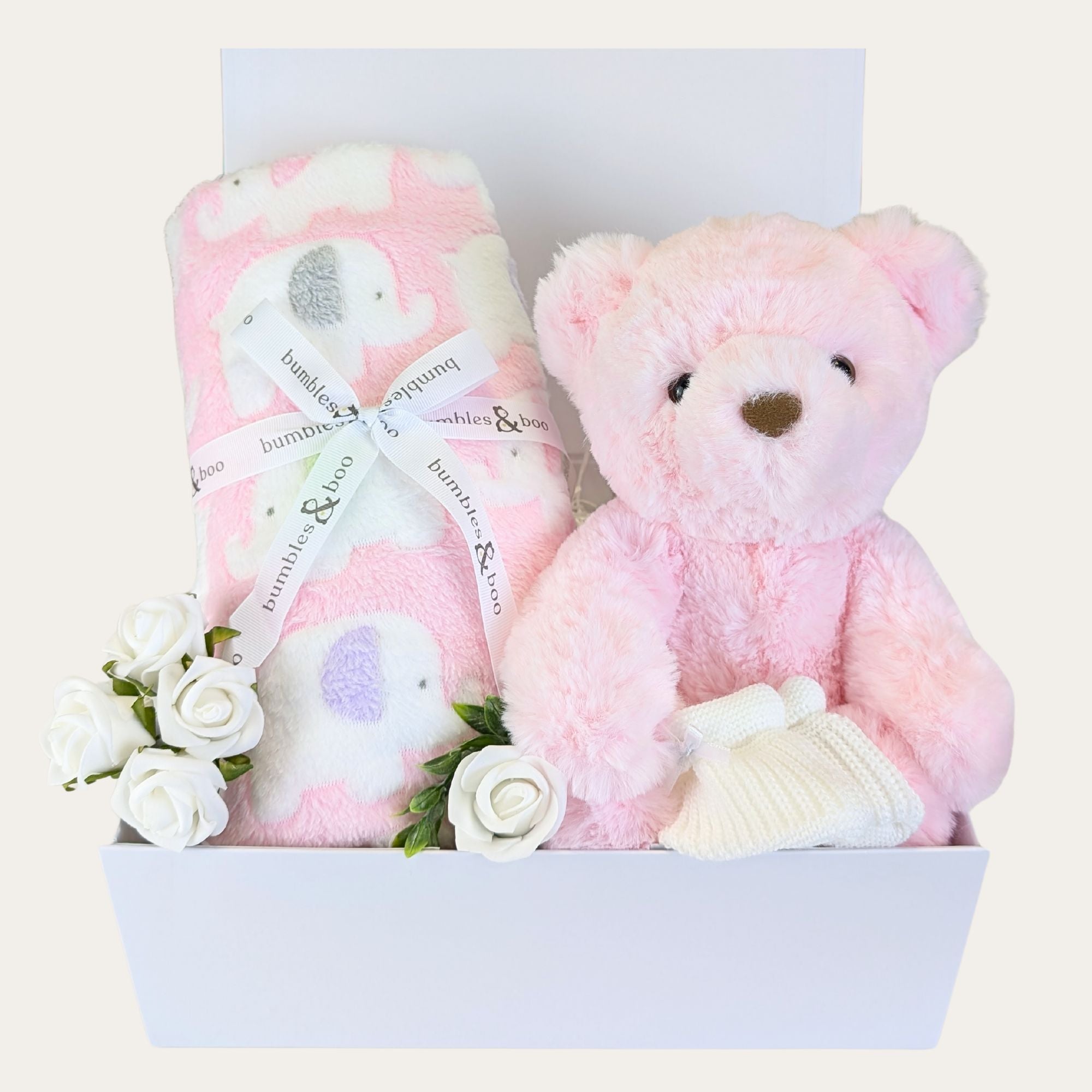 baby girl gifts hamper with pink teddy, elephant blanket and baby knit booties. In a white gift box with lid.