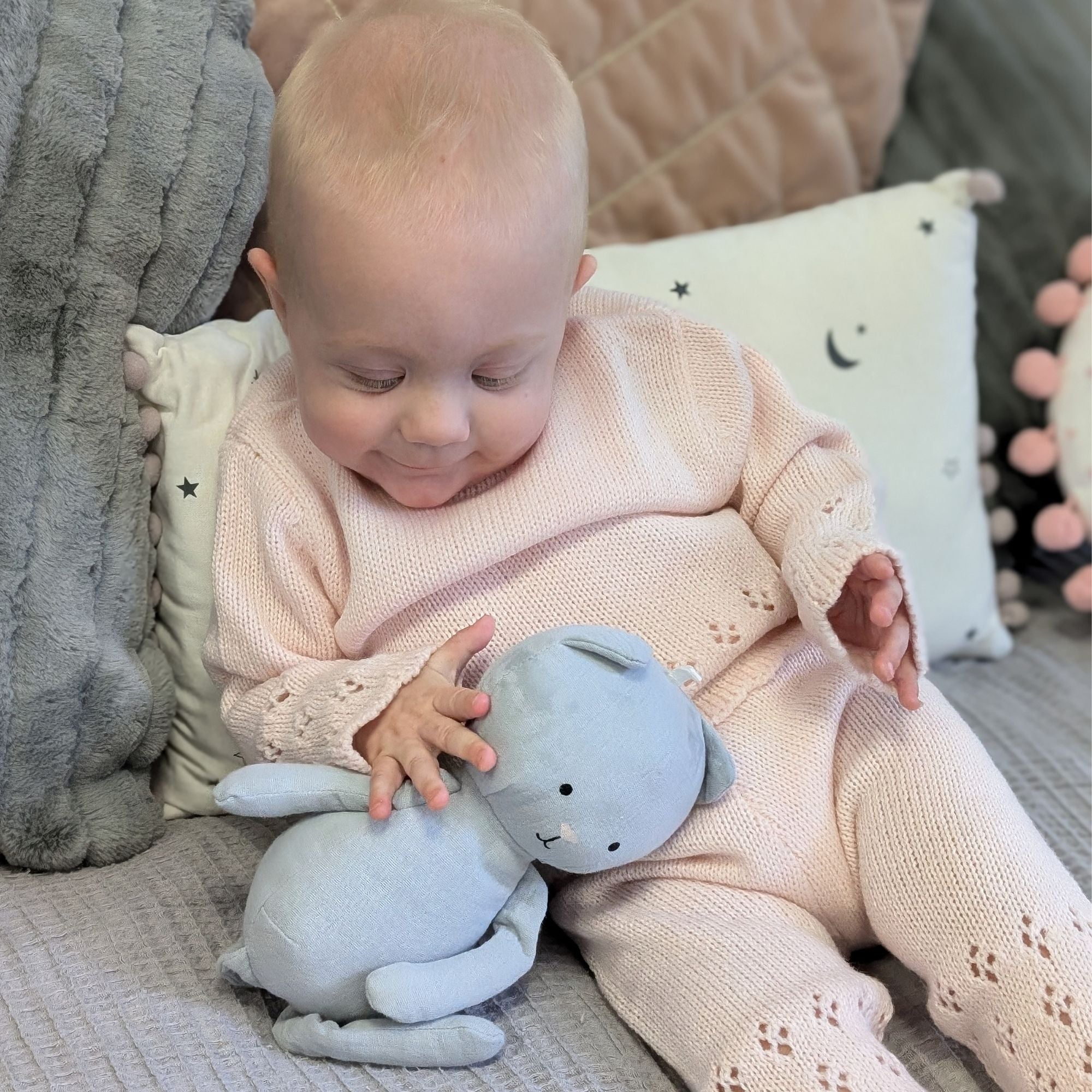 baby in pink knit clothing set