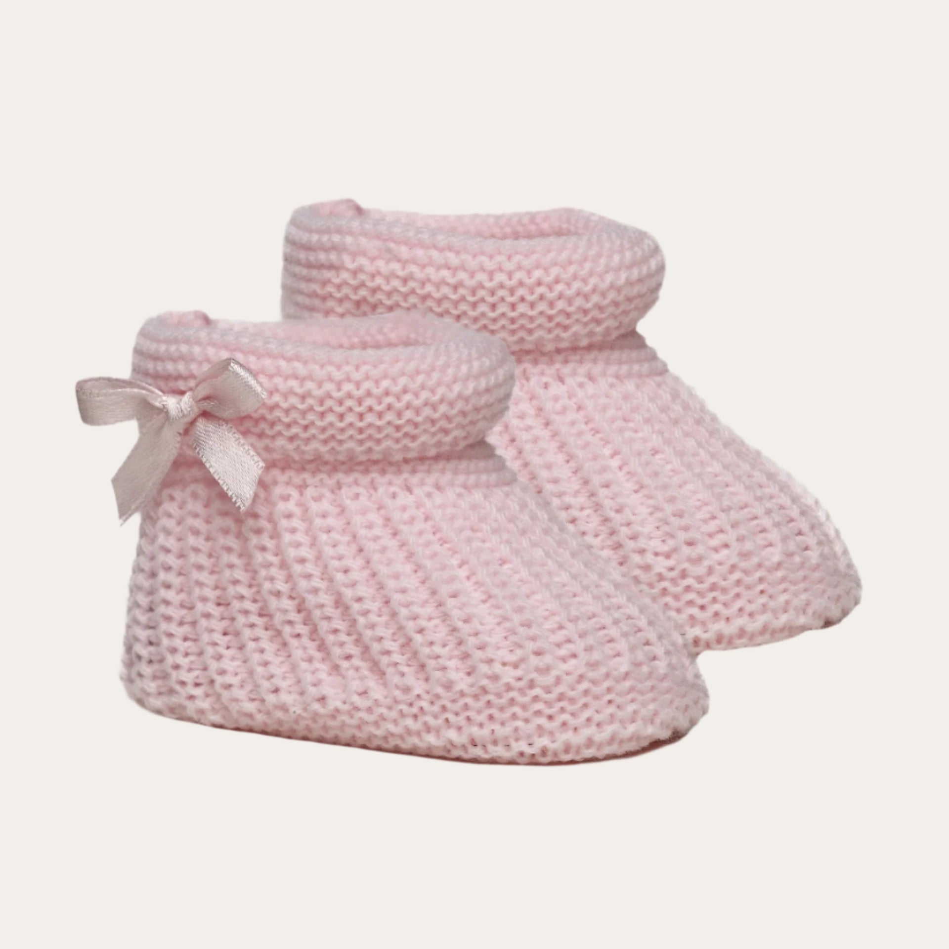 baby pink plain knit baby bootees with bow detail for newborns