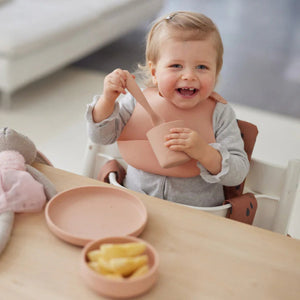 Children’s Silicone Tableware Set in pale pink, including a suction plate, bowl, spoon, and cup.