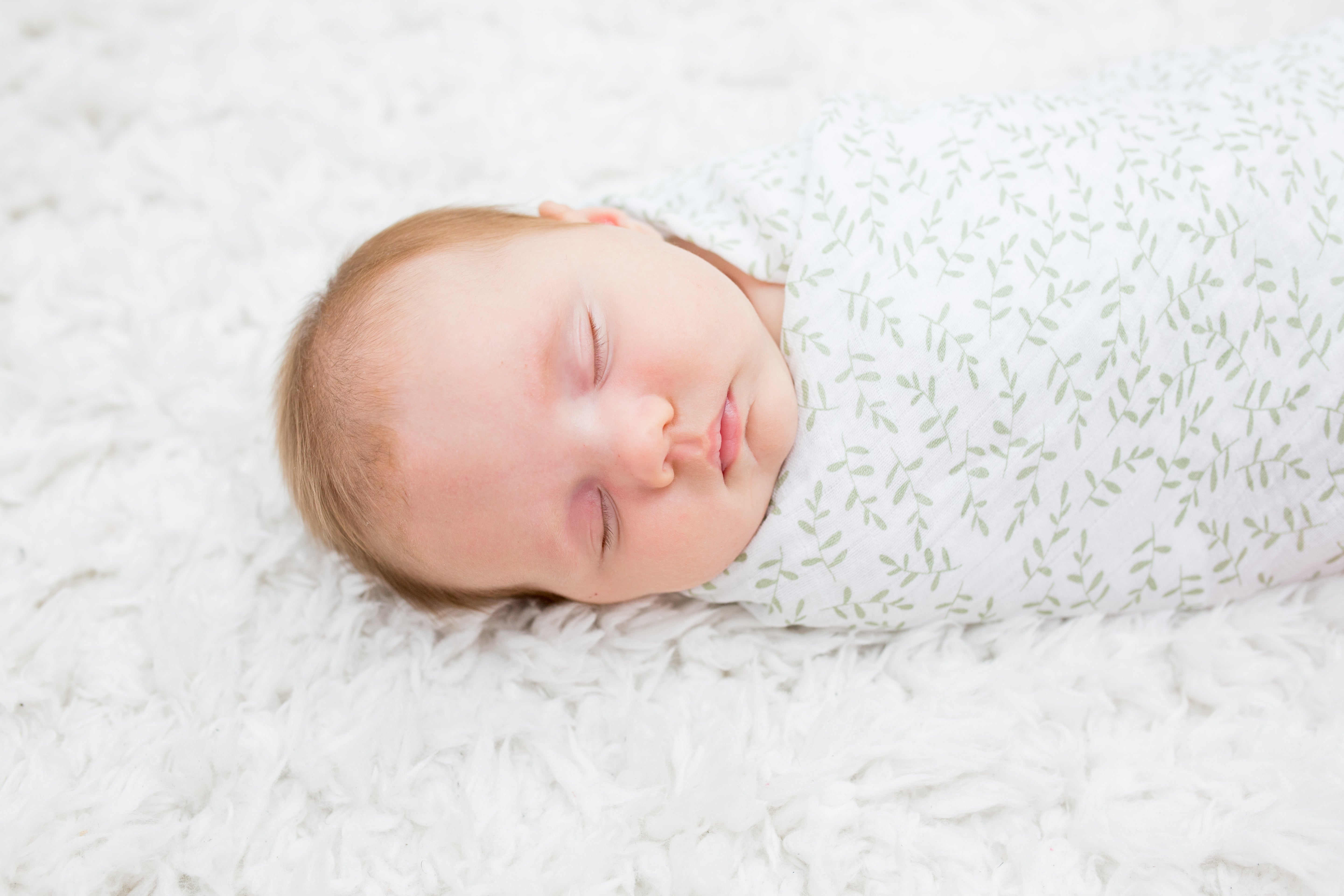 White and green baby swaddle muslin. 100% soft cotton muslin.