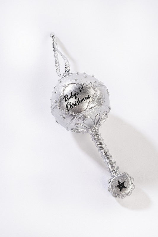 A silver coloured hanging Christmas ornamental rattle for the Christmas tree with the sentiment 'Baby's 1st Christmas' 