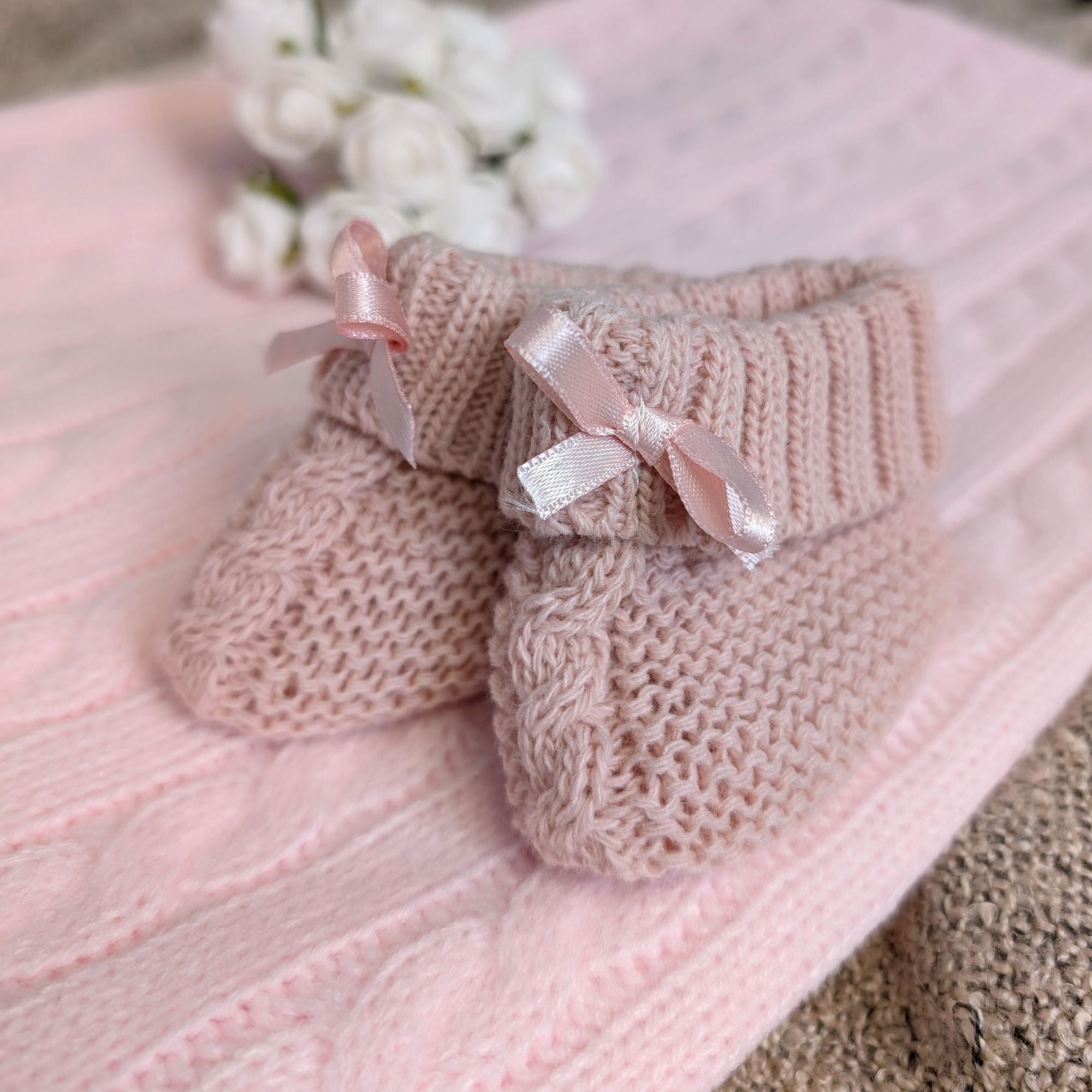 rose gold knit baby booties with little rose gold bows