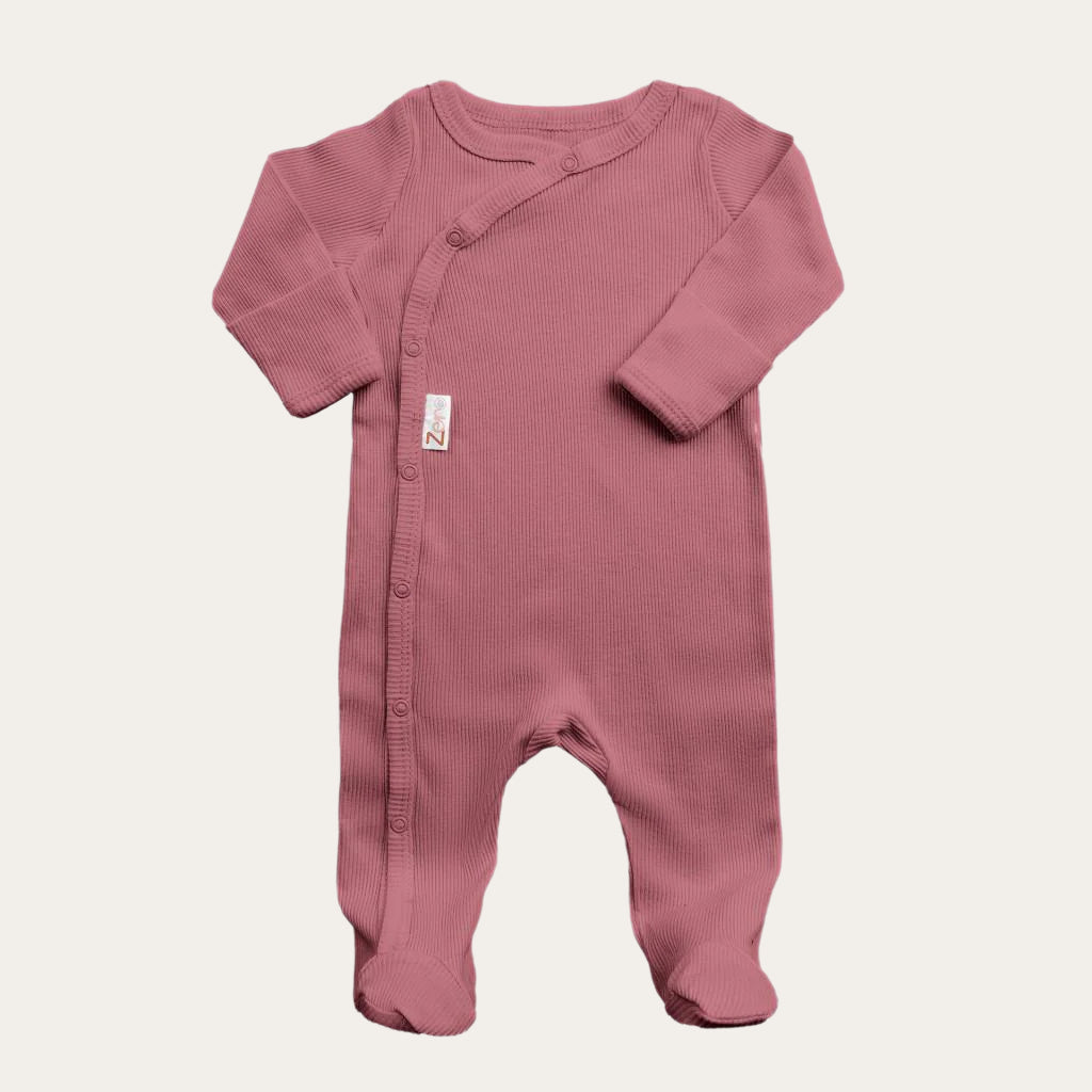 dusty pink ribbed sleepsuit displayed flat, showing front and leg poppers