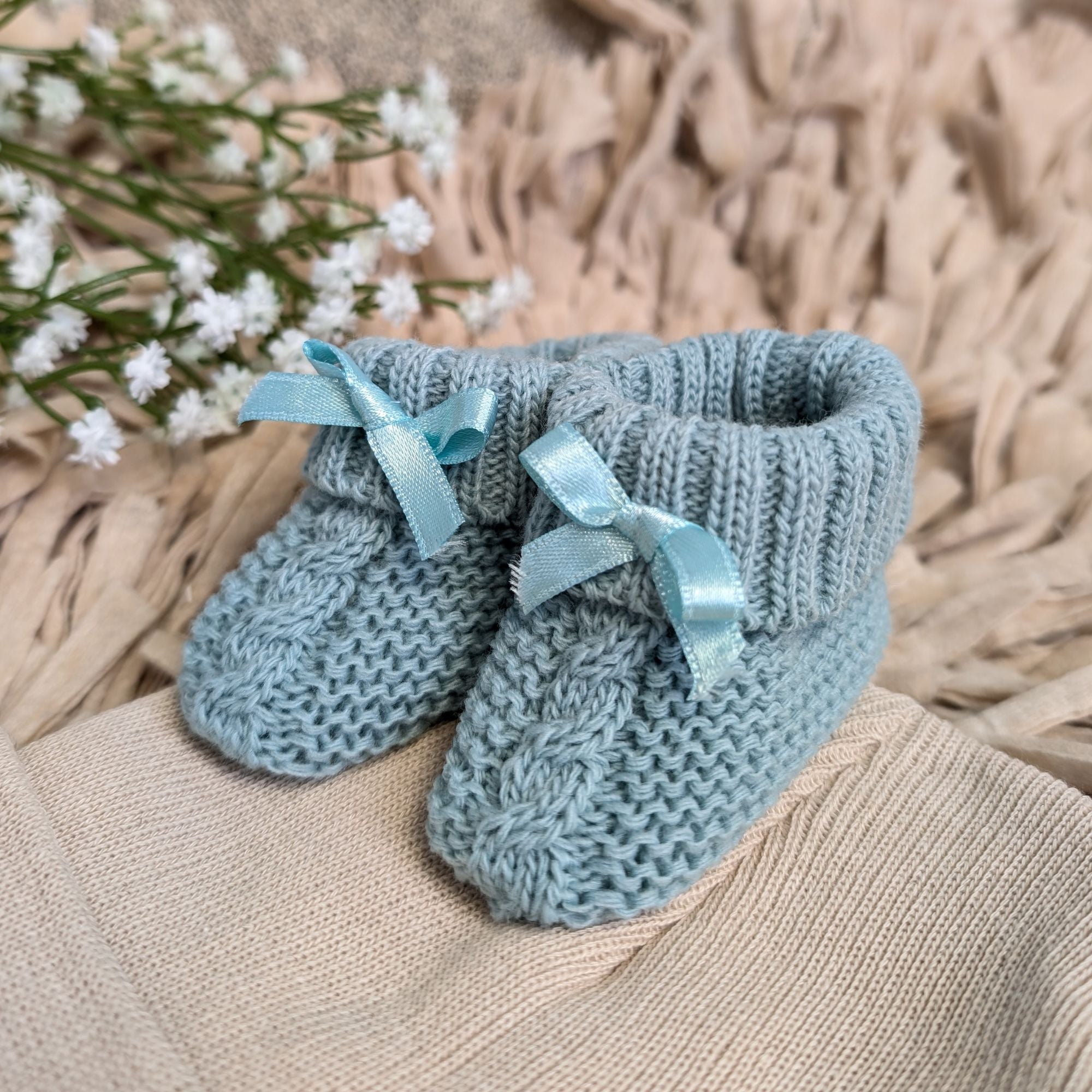 sage green knit baby booties with little green bows