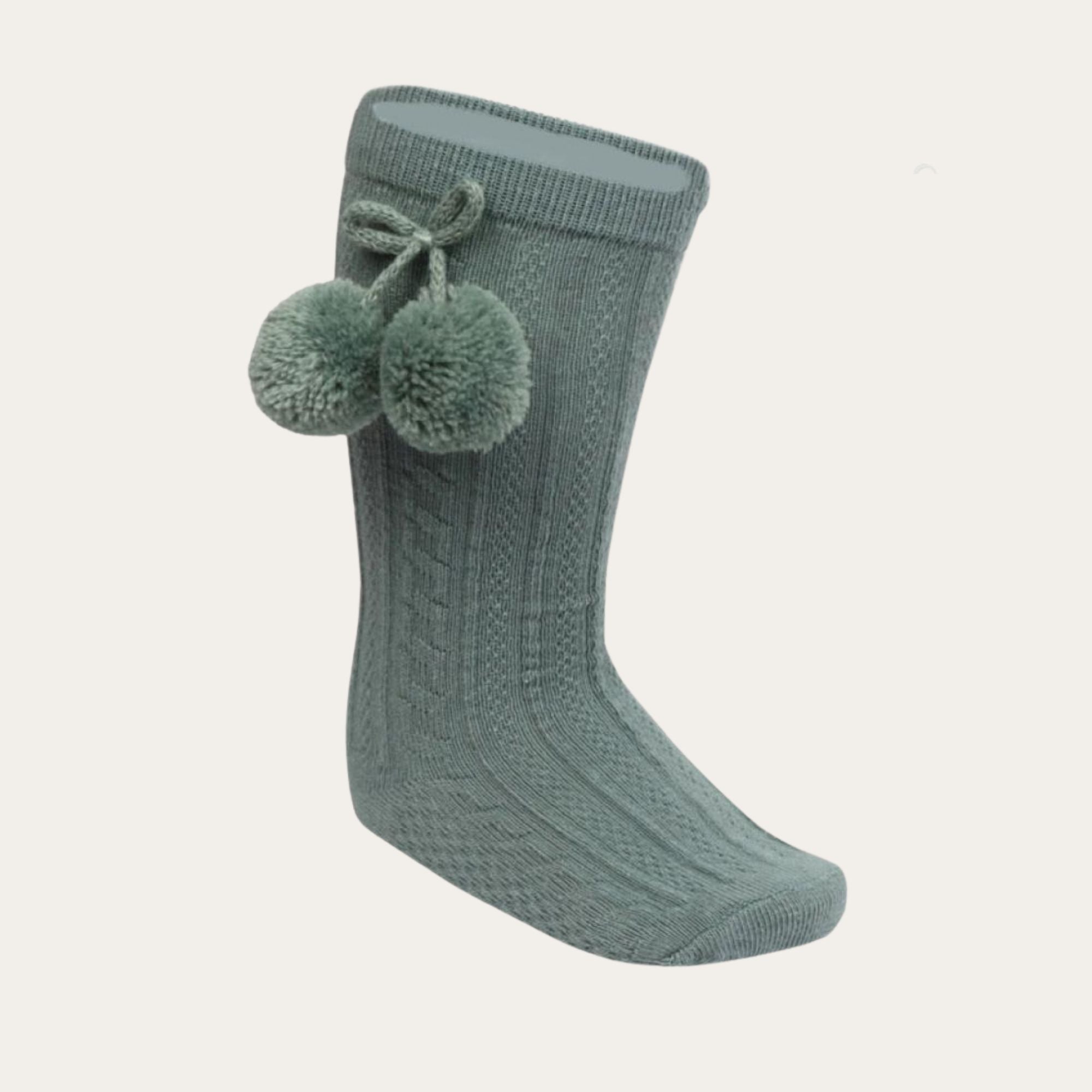 Sage Green knee length baby socks with cable pattern with adorable pom pom detail 