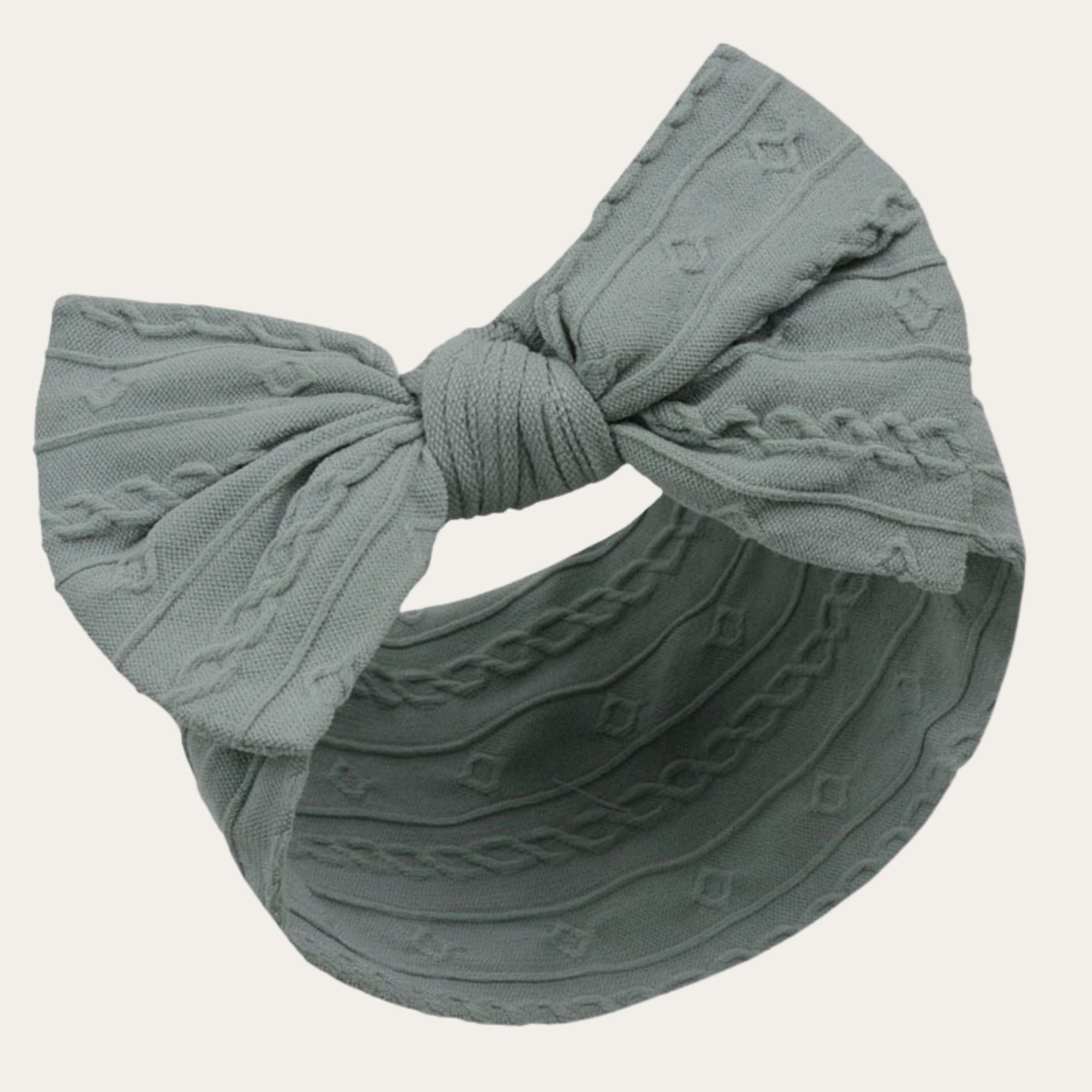 Cute Baby headband in a soft sage green with cable knit design and bow detail. 