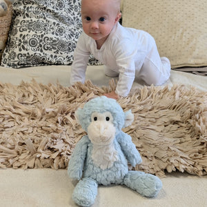 Baby crawling towards the seafoam monkey.