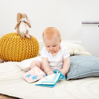 Nutbrown Hares soft square book featuring bright illustrations, textured patches, crinkle and squeaky pages, with a clip ring for pram attachment. Ideal for babies and toddlers