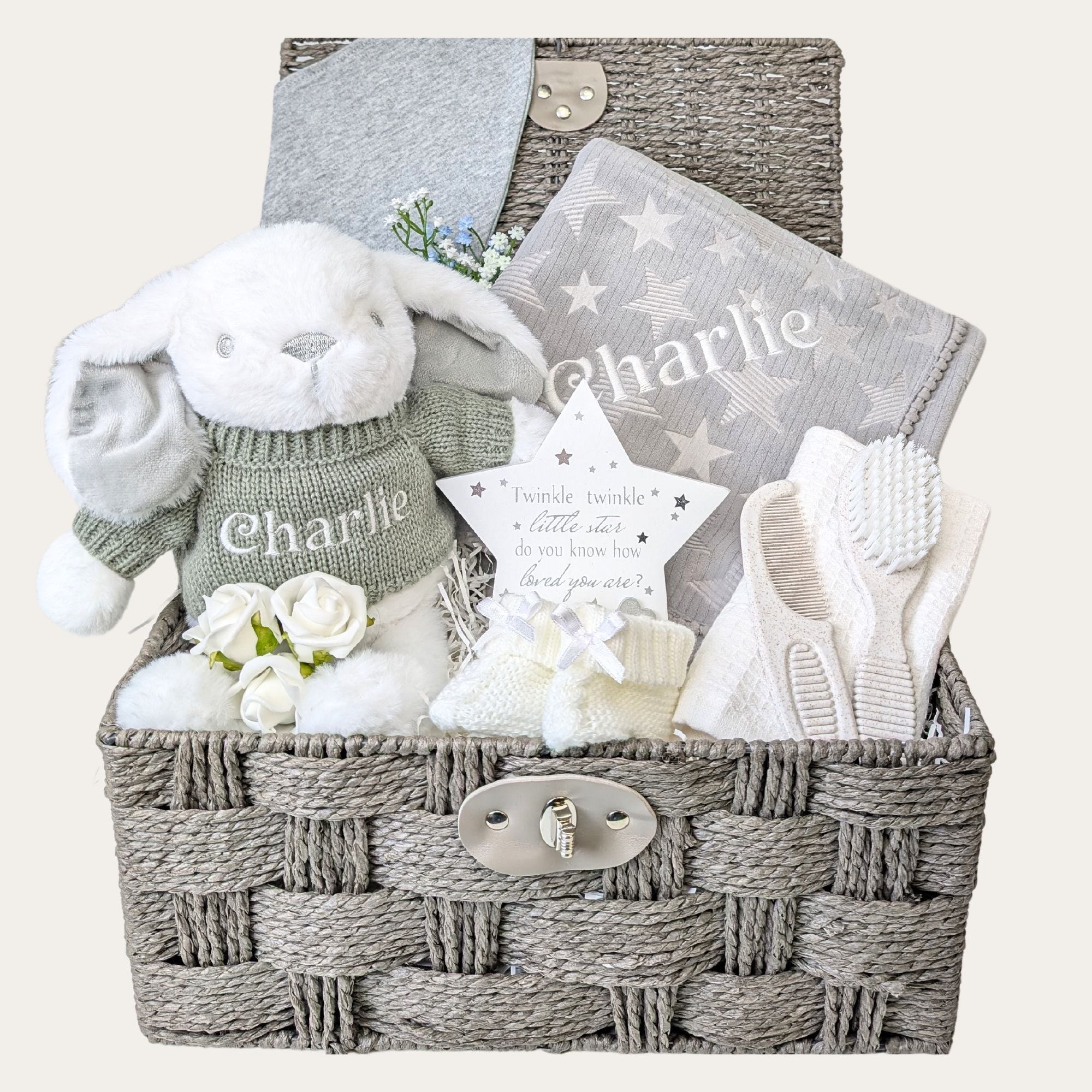 Unisex baby gift hamper with a soft grey blanket, bunny soft toy, eco-friendly flannel, brush and comb set, nursery plaque, bib, and white baby knit booties. Bumbles and Boo