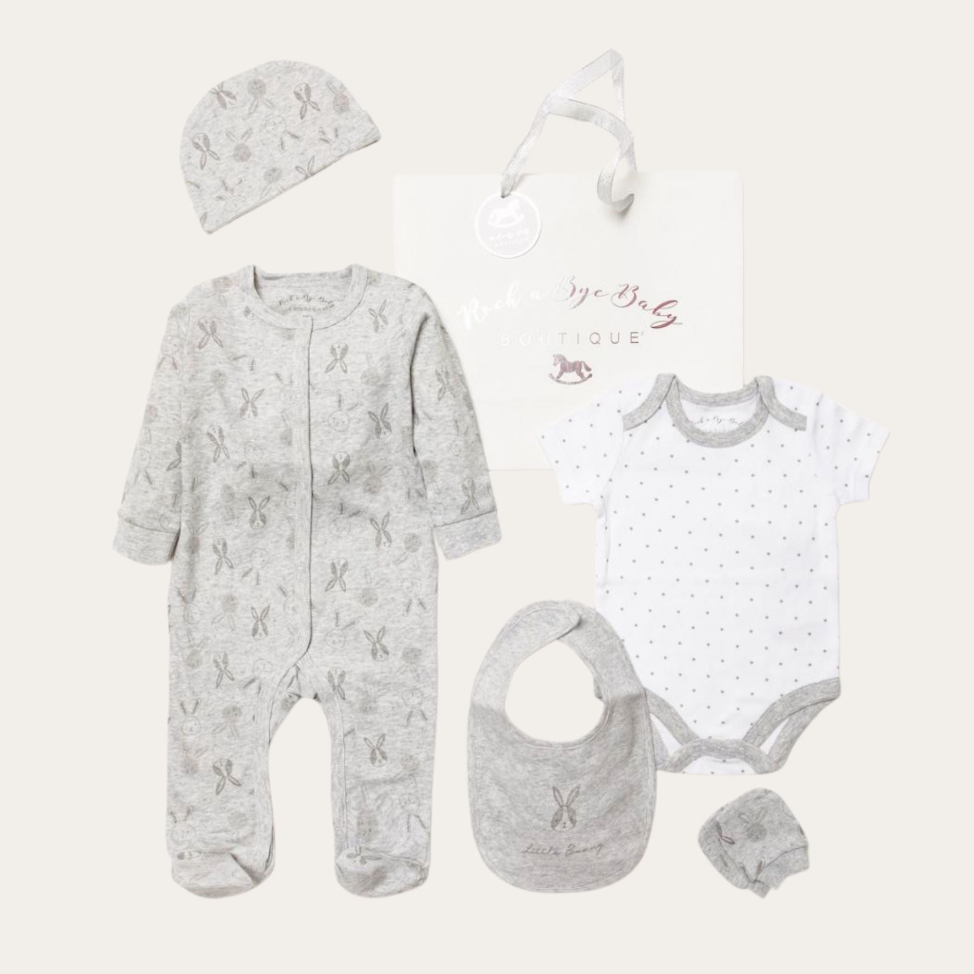 grey baby clothing gifts set in grey cotton which includes sleepsuit, hat, vest, mittens and bib with a gifts bag