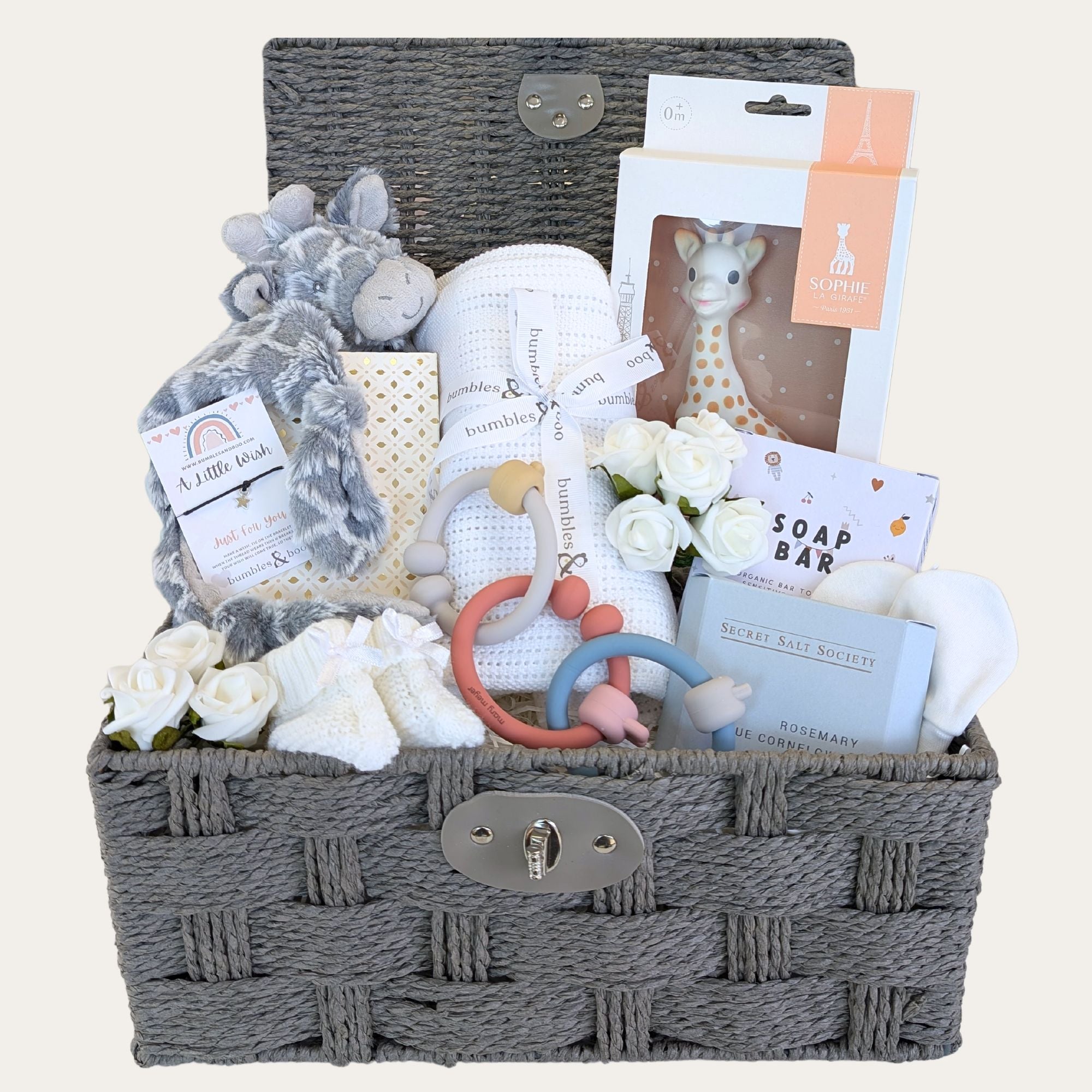 Baby gifts in a hamper basket with baby toys and blanket.