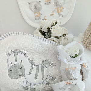 new baby hamper gift. Clothing set to include bib, vest, romper and hat. Elephant baby hand rattle, zebra hooded bath towel and baby mittens.