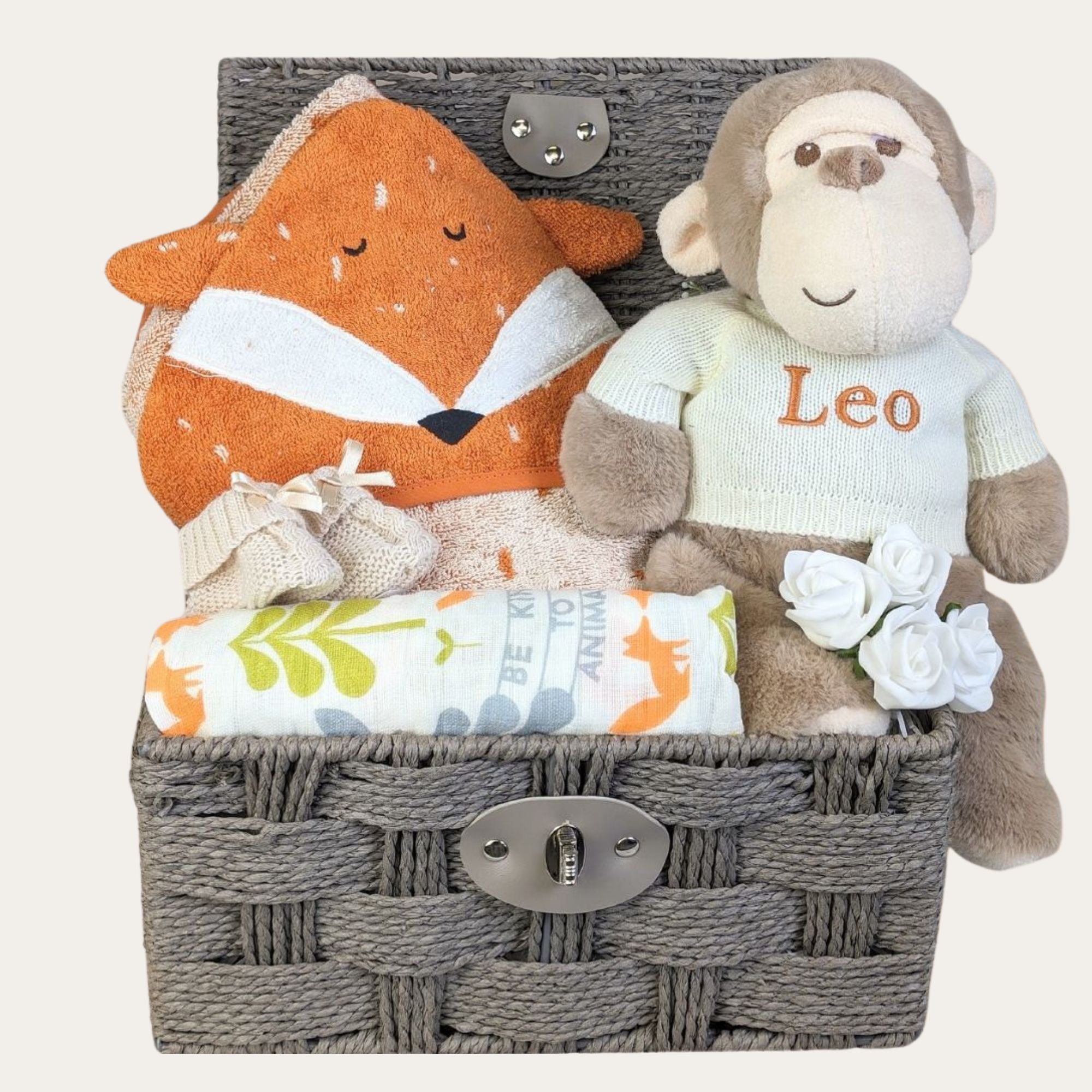 Unisex baby hamper basket with gifts of monkey soft toy wearing a personalised jumper and fox theme.