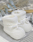 White baby booties with tie ups.