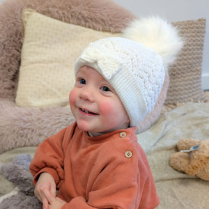 white pompom hat with bow