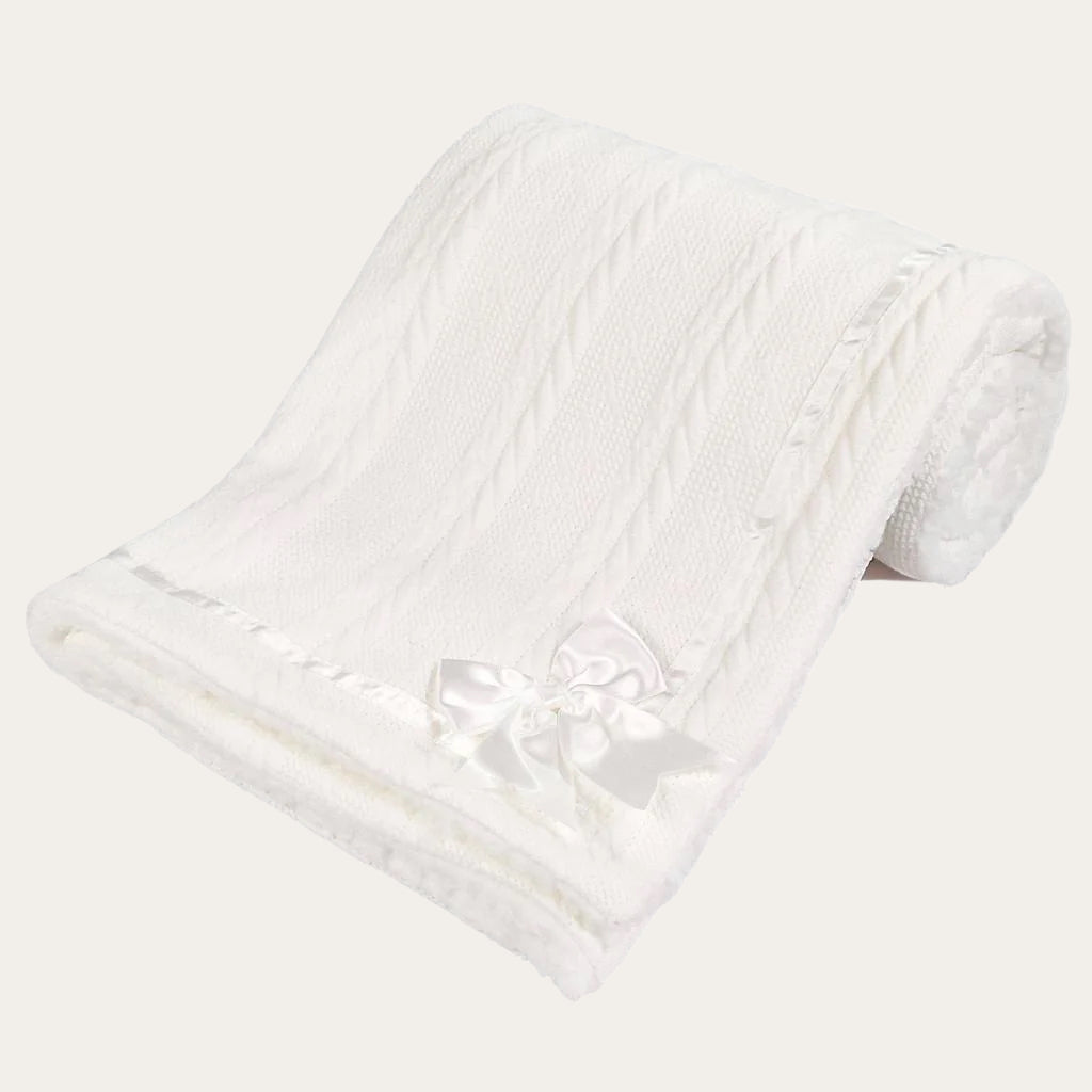 White Sherpa Back Knit Blanket folded neatly, showing the satin bow