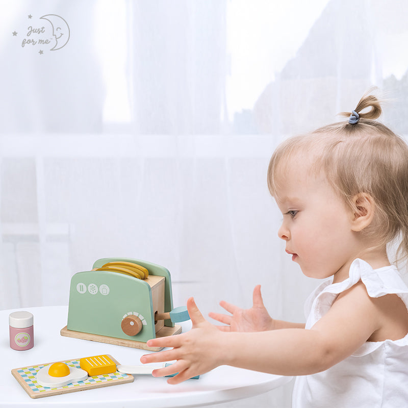 Wooden toy toaster with 8 pieces with toddler playing.