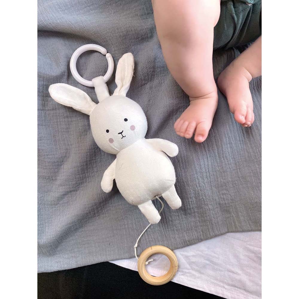 White bunny musical pull down toy to keep baby amused whilst in a car seat or pram.