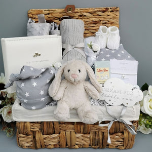 Baby gifts in a hamper basket with bnny and stars grey theme.